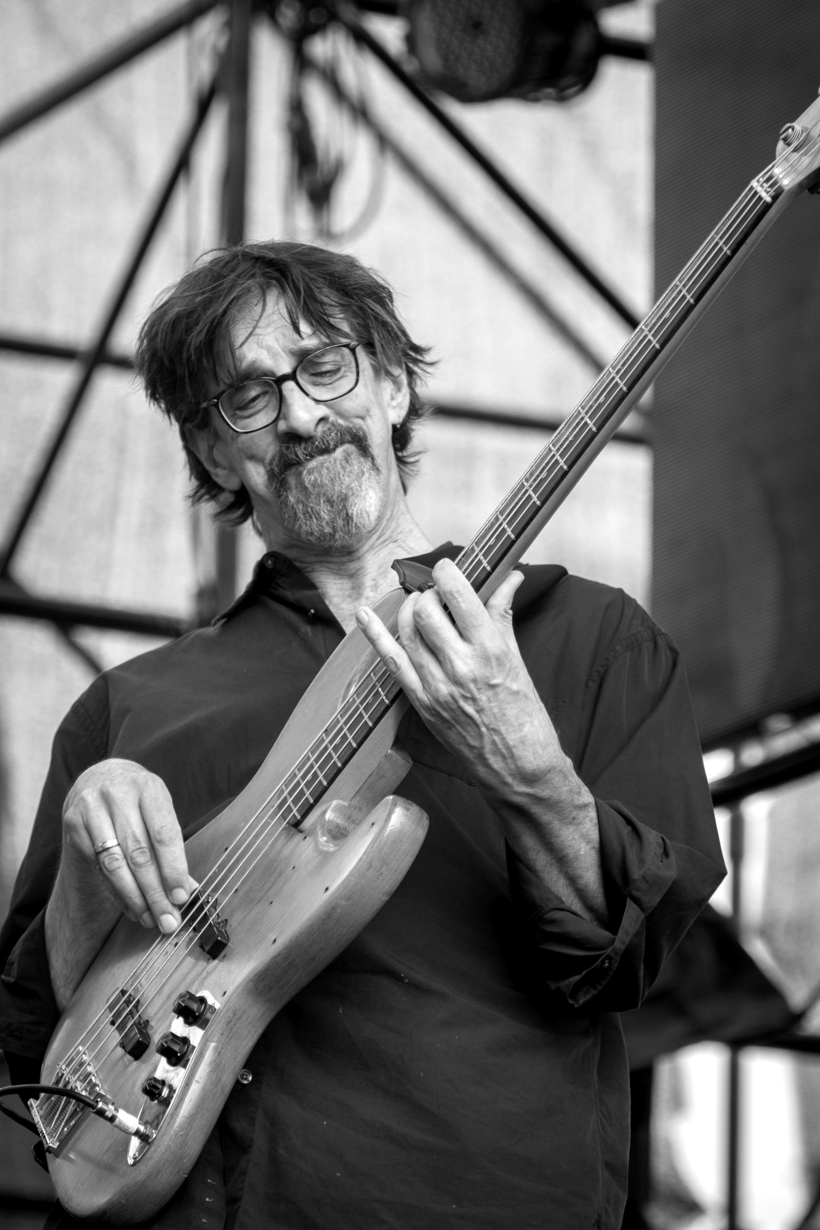 Ritt Henn playing electric bass on a festival stage