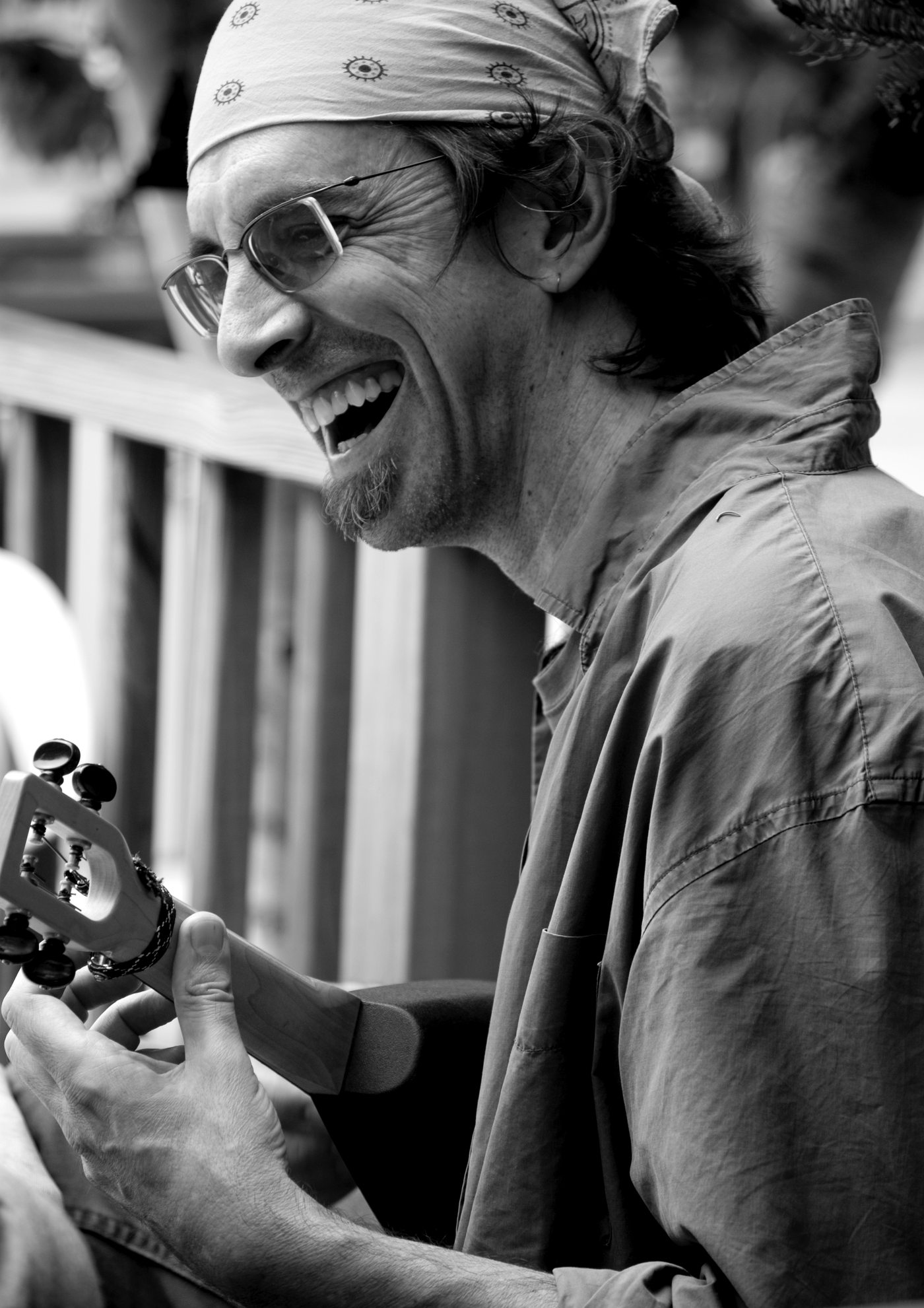 Ritt laughing, in a bandana, playing ukulele