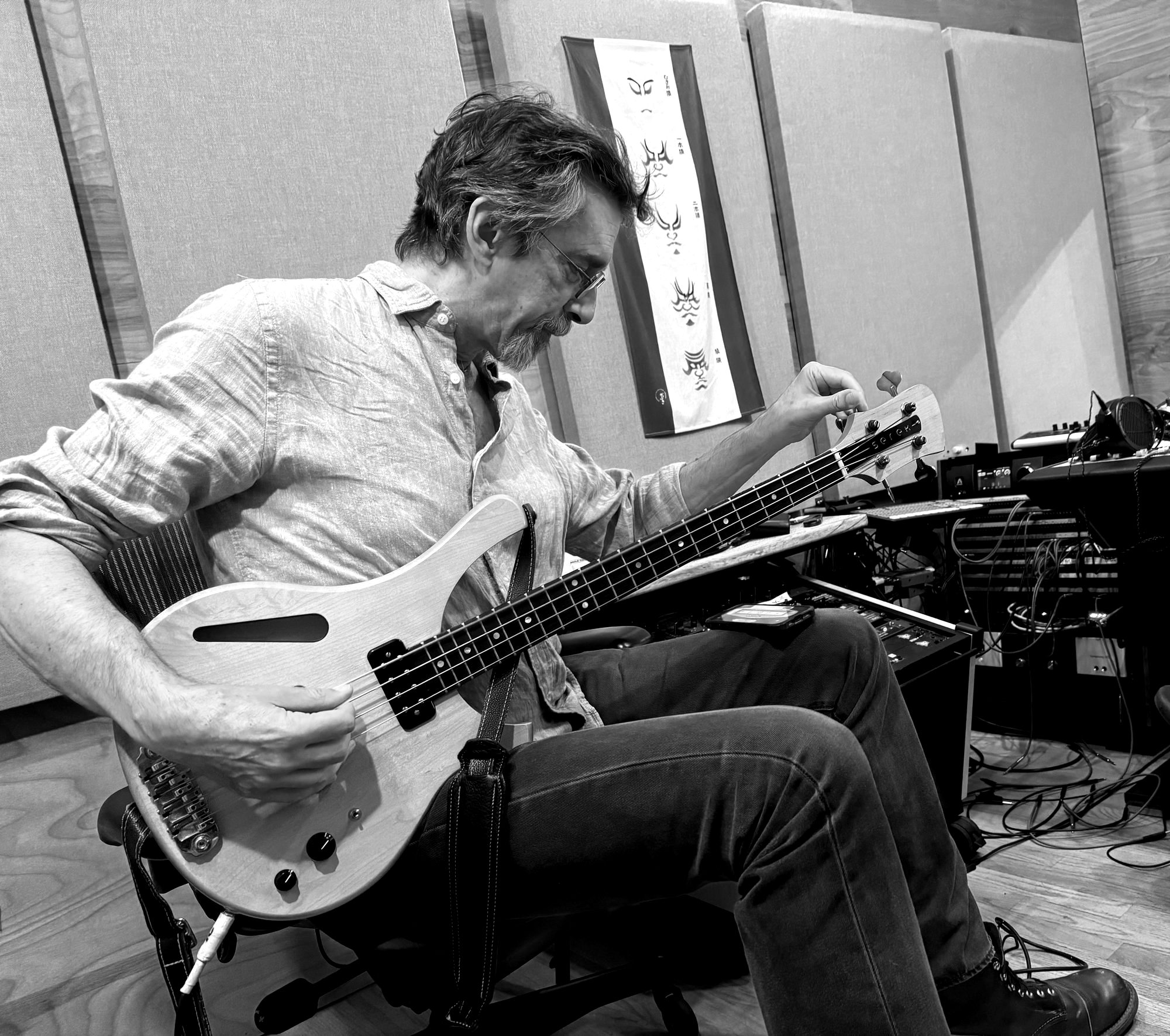 Ritt tuning an electric bass in the studio