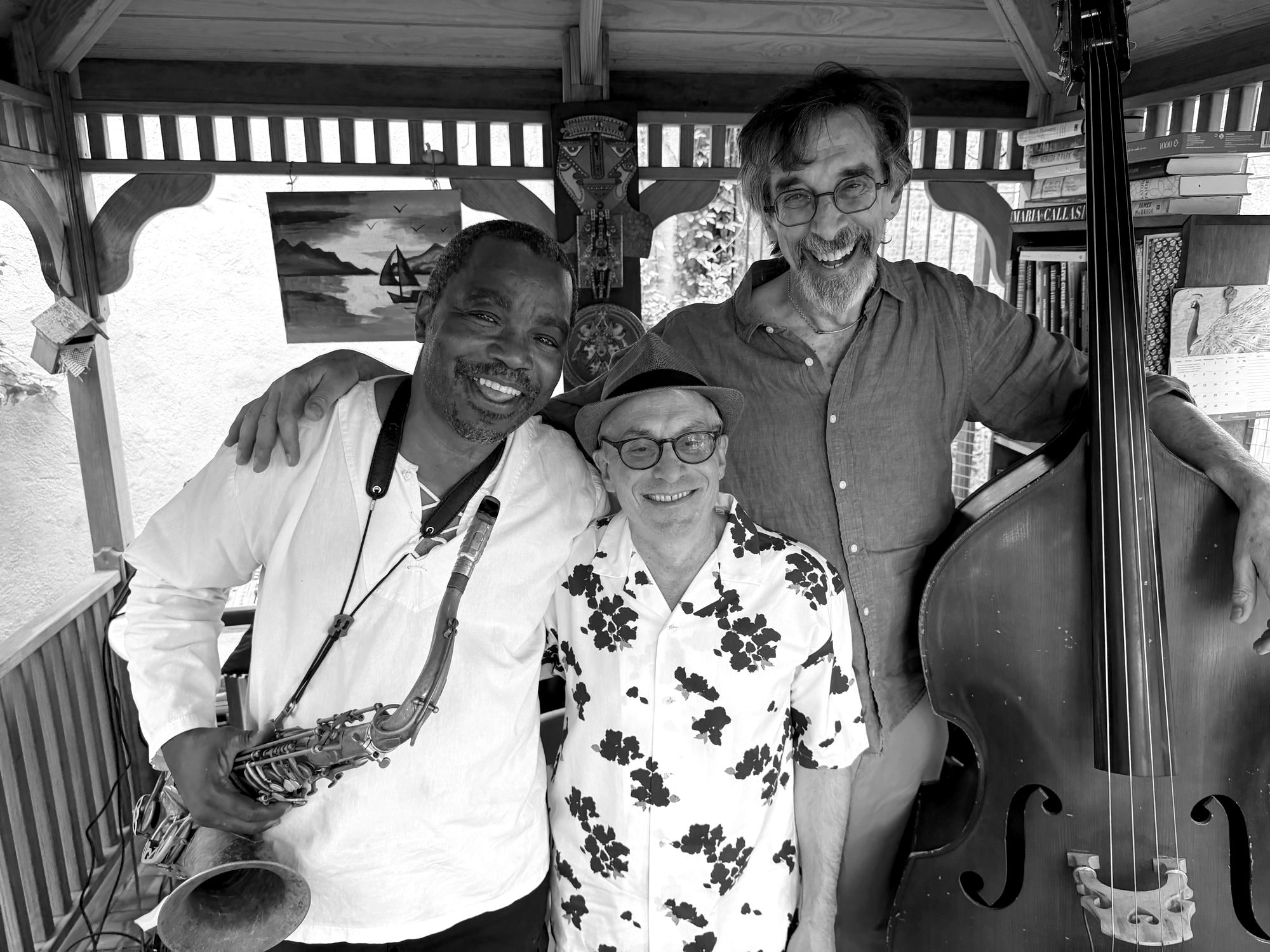 Ritt with his upright bass and two musician friends under a gazebo