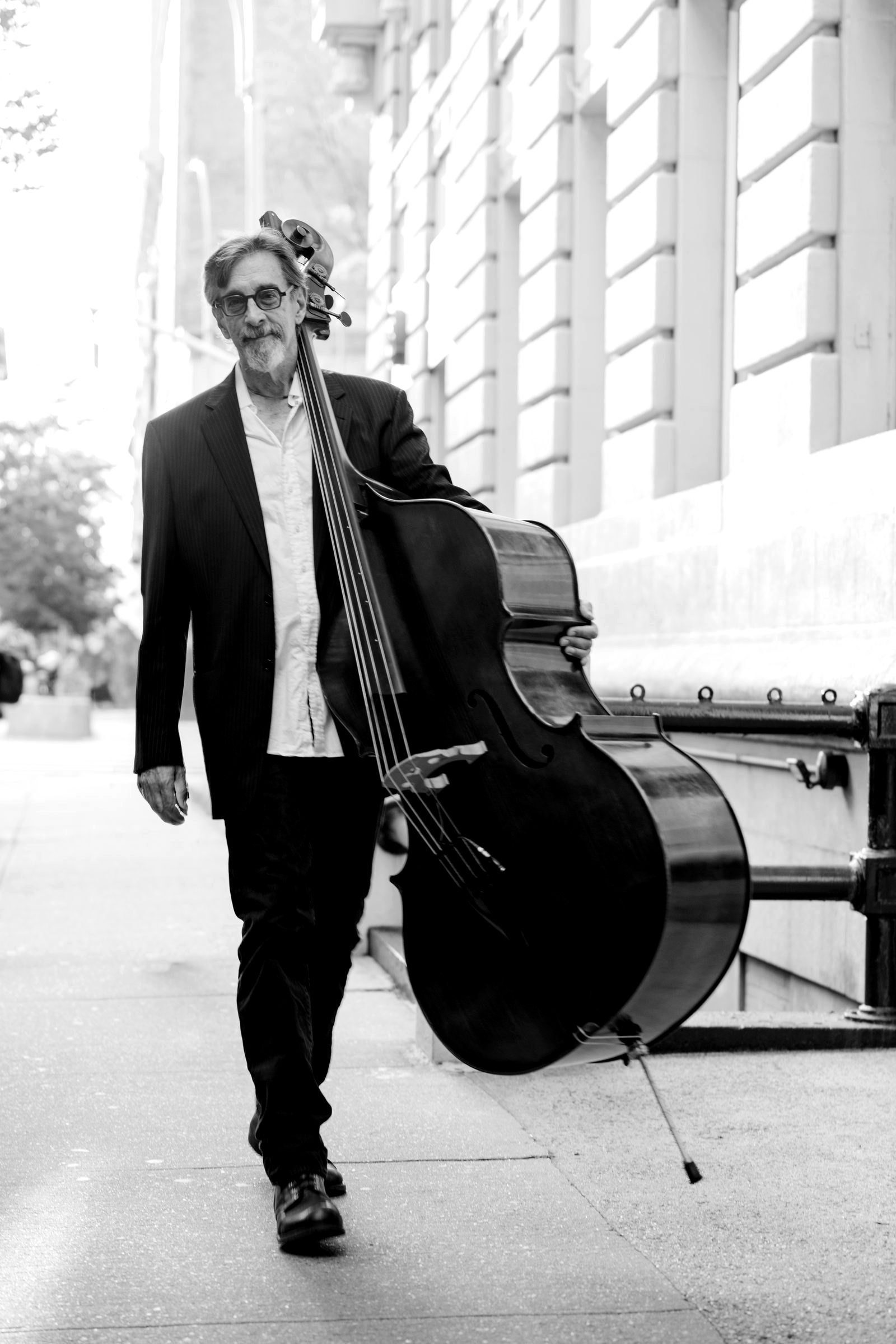 Ritt walking a New York sidewalk with his upright bass